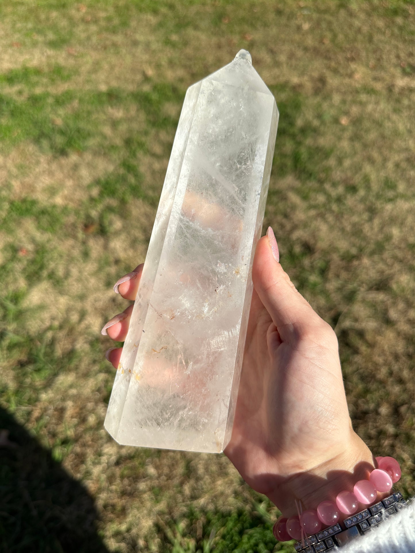 Clear quartz tower with hematite inclusions, 8in tall, 2.5in wide.