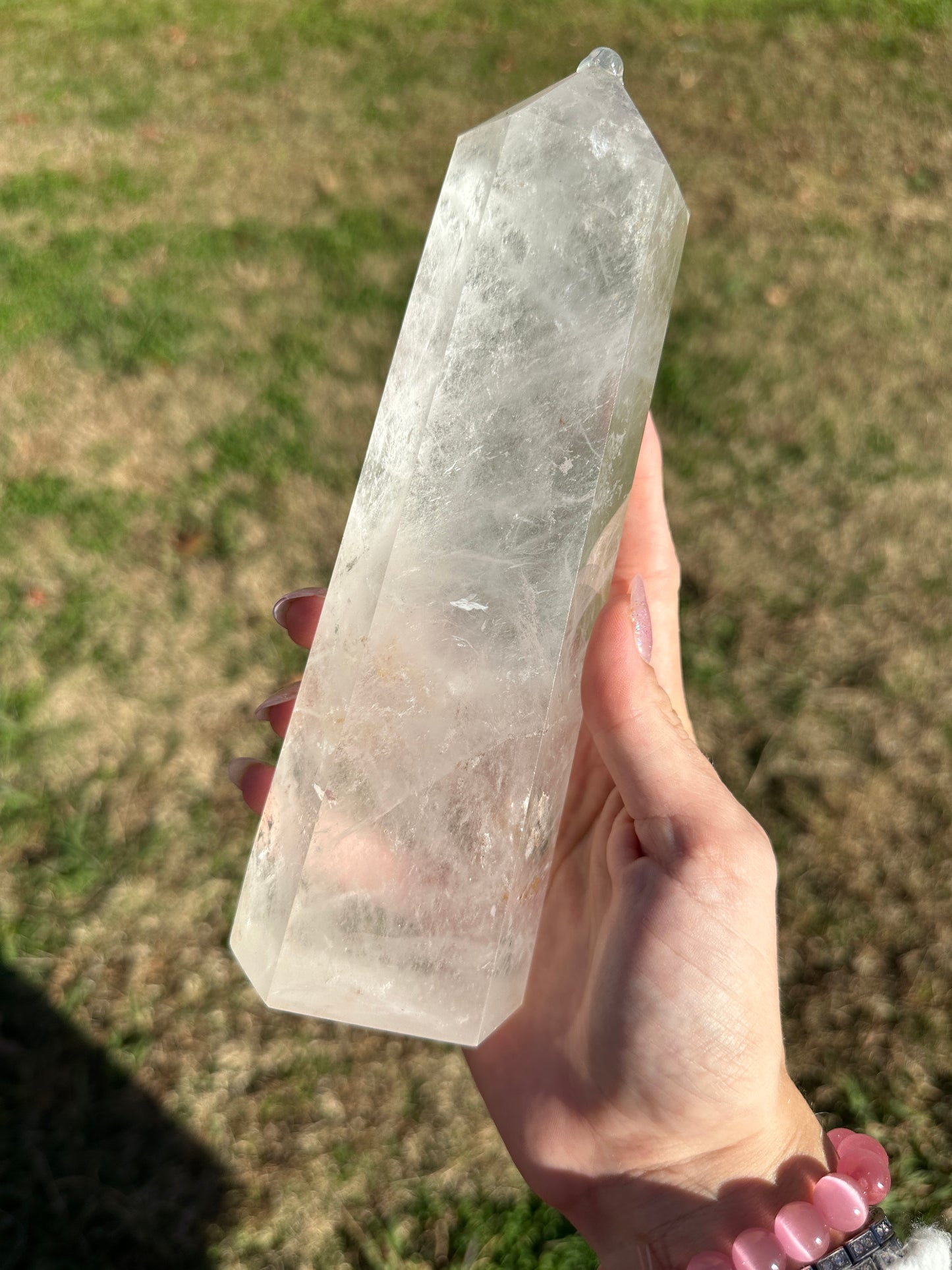 Clear quartz tower with hematite inclusions, 8in tall, 2.5in wide.