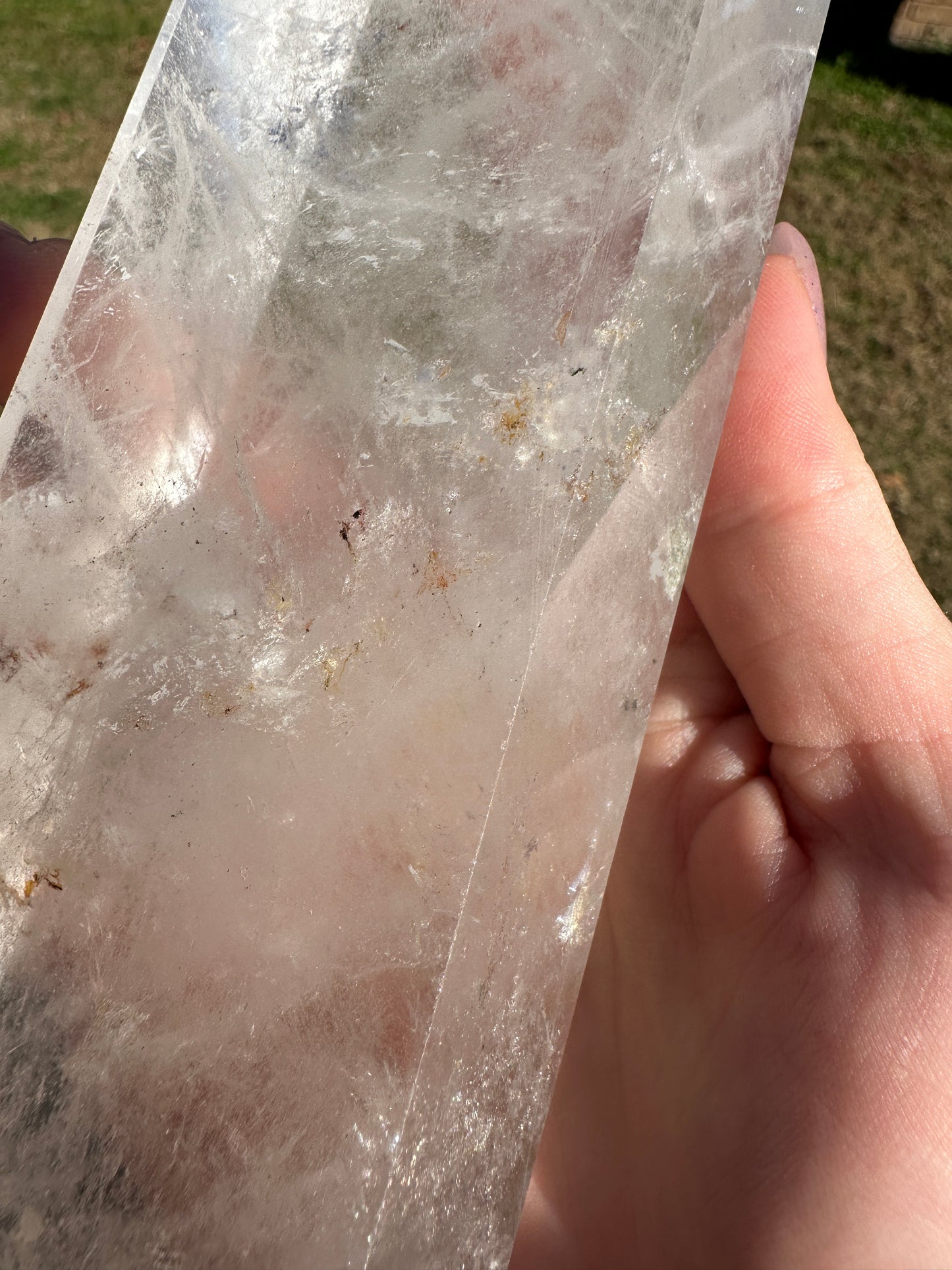 Clear quartz tower with hematite inclusions, 8in tall, 2.5in wide.