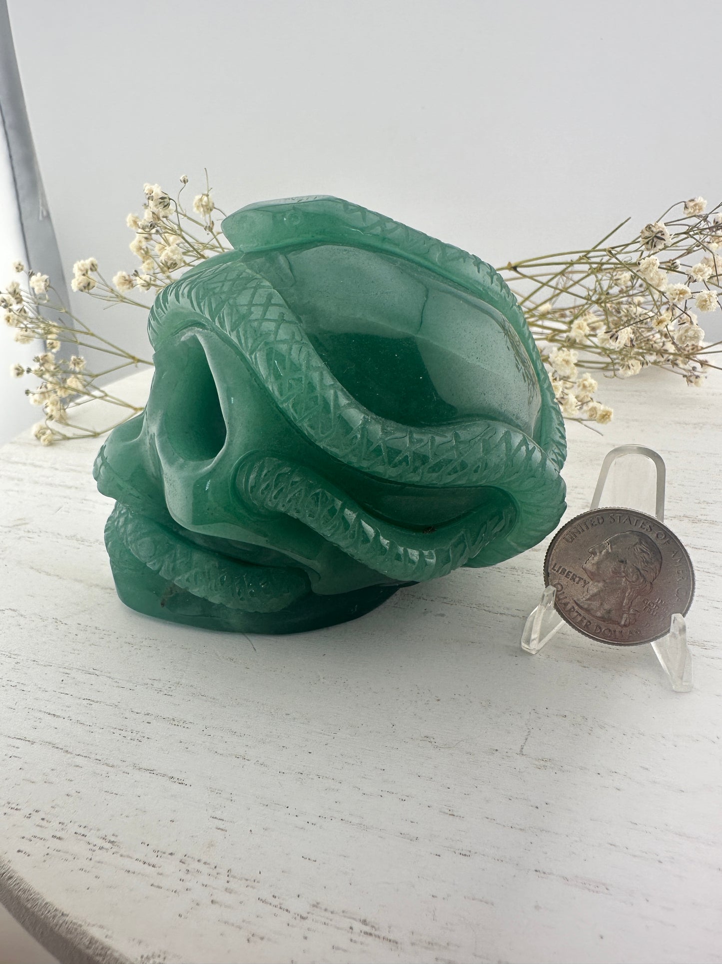 Green aventurine skull with snakes carving