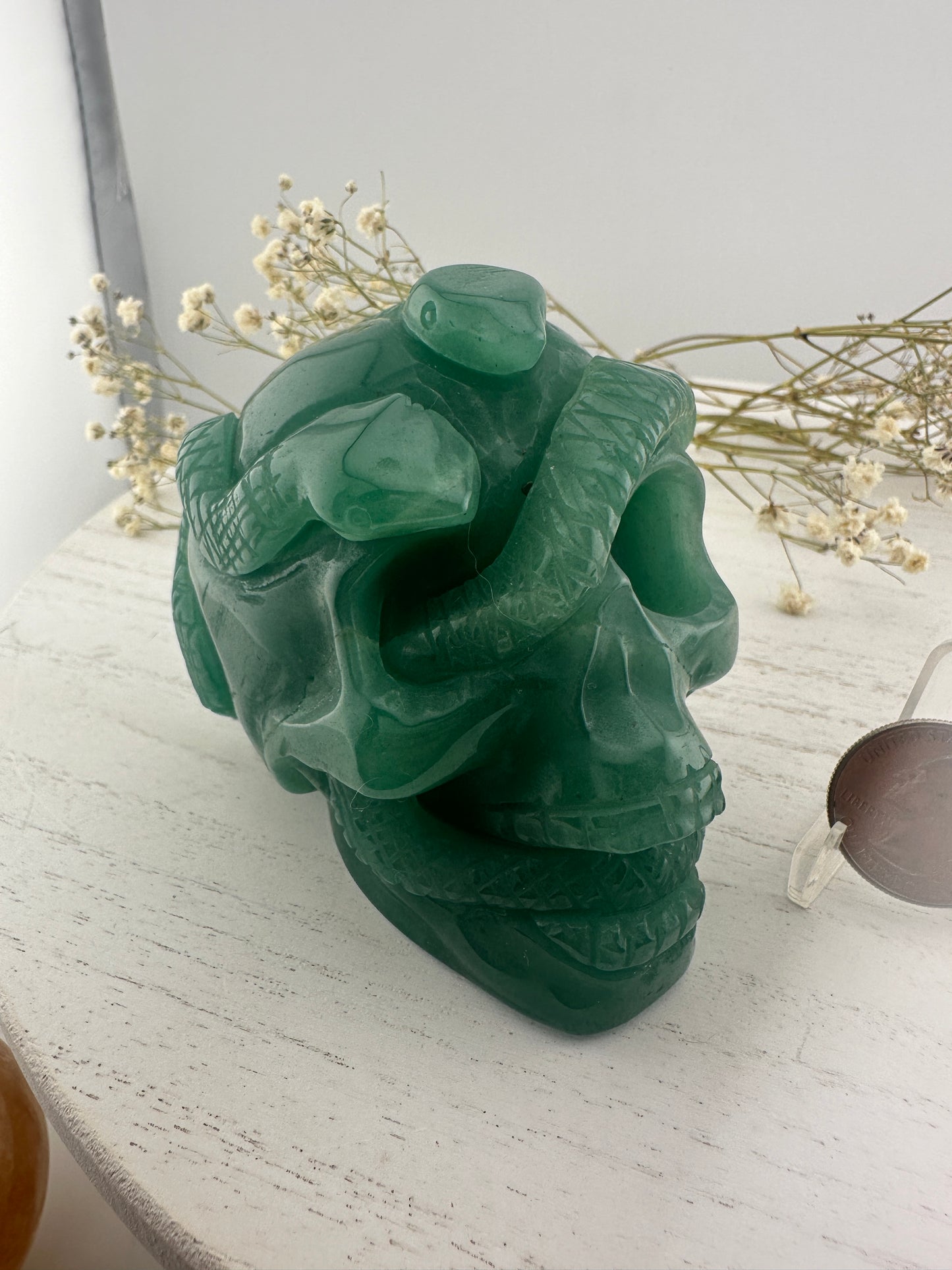 Green aventurine skull with snakes carving